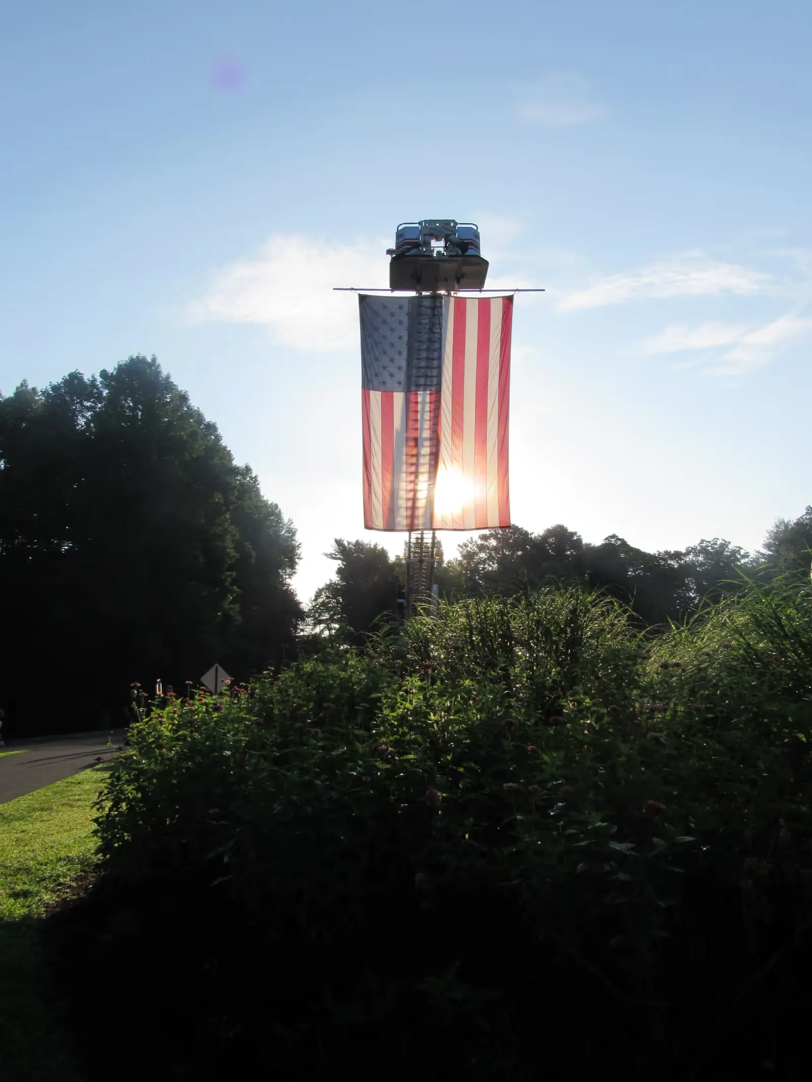 The colors fly from the ladder truck at sunrise