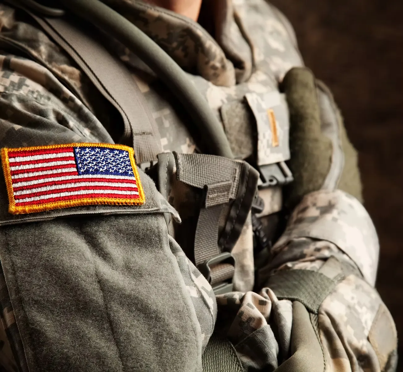 A United States soldier in uniform, the flag patch on the shoulder